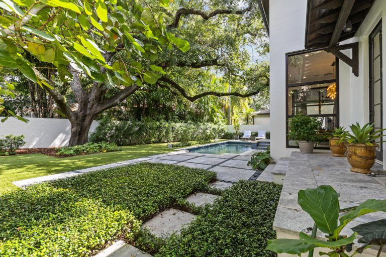 68-Backyard Luxury home backyard with pool, landscaping, and shaded patio photographed for real estate marketing content